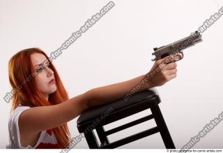 TINA KNEELING POSE WITH GUNS